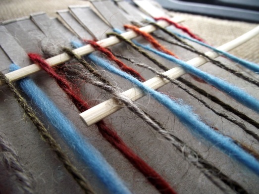 The skewers being woven through the yarn.